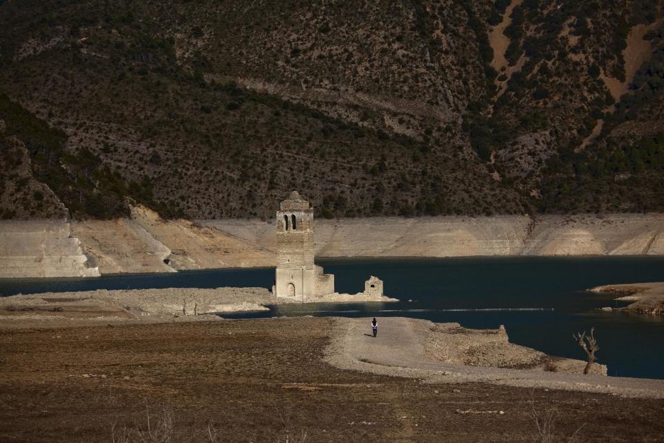 A church and remains of an ancient village which are usually covered by water are seen inside the reservoir of Mediano, in Huesca, Spain, Tuesday March 13, 2012. One reservoir built in the 1950s, submerging a village called Mediano and its 16th century church, is so low on water that the ruins of buildings which are usually under water are now uncovered. Spain is suffering the driest winter in more than 70 years, adding yet another woe for an economically distressed country that can scarcely afford it. Thousands of jobs and many millions of euros could be in jeopardy. (AP Photo/Emilio Morenatti)