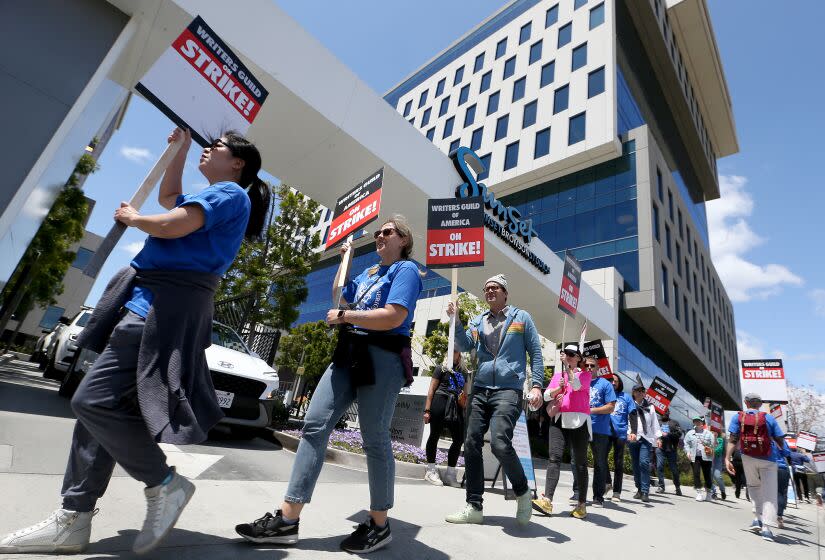 Los Angeles, CA - May 02: Striking Writers Guild of America workers picket outside the Sunset Bronson Studios on Tuesday, May 2, 2023. Los Angeles on Tuesday, May 2, 2023 in Los Angeles, CA. (Luis Sinco / Los Angeles Times)