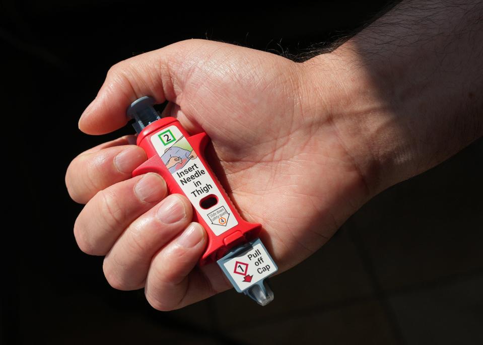 To use a naloxone shot, press the button and it will insert a small needle with a dose. Naloxone reverses fentanyl overdoses.