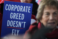 A flight attendant holds a sign during a protest at O'Hare International Airport in Chicago, Tuesday, Feb. 13, 2024. Three separate unions representing flight attendants at major U.S. airlines are picketing and holding rallies at 30 airports on Tuesday as they push for new contracts and higher wages. (AP Photo/Nam Y. Huh)