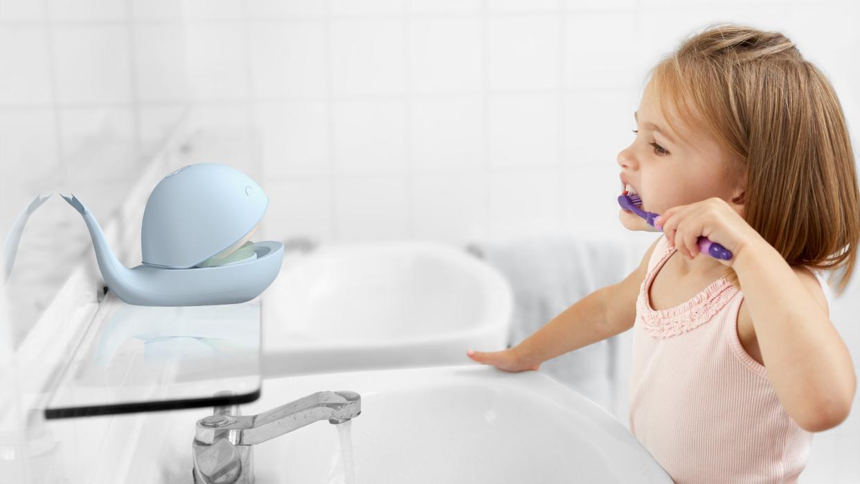 A child uses University of Notre Dame student Julia Cutajar's Swishy to guide her through brushing her teeth correctly.