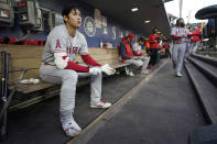 Los Angeles Angels' Shohei Ohtani sits in the dugout before batting during the fifth inning of the team's baseball game against the Seattle Mariners, Thursday, June 16, 2022, in Seattle. (AP Photo/Ted S. Warren)