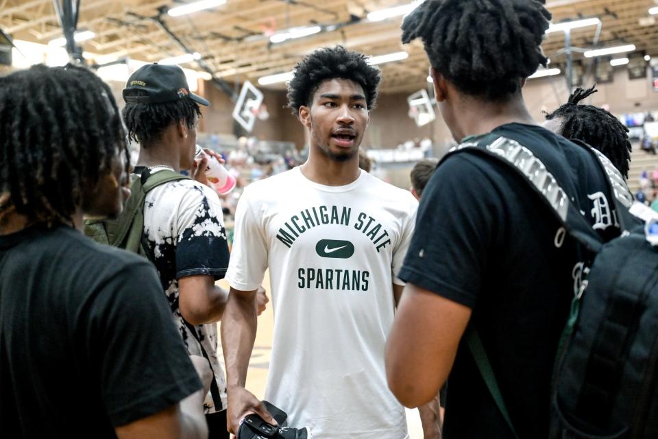 Michigan State's Jaden Akins, center, talks with MSU teammate AJ Hoggard on Thursday, June 30, 2022, during the Moneyball Pro-Am at Holt High School. 