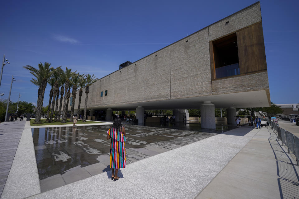 A visitor takes a picture at the opening of the International African American Museum on Saturday, June 24, 2023, in Charleston, S.C. Overlooking the old wharf at which nearly half of the enslaved population first entered North America, the 150,000-square foot museum houses exhibits and artifacts exploring how African Americans' labor, perseverance, resistance and cultures shaped the Carolinas, the nation and the world. (AP Photo/Chris Carlson)