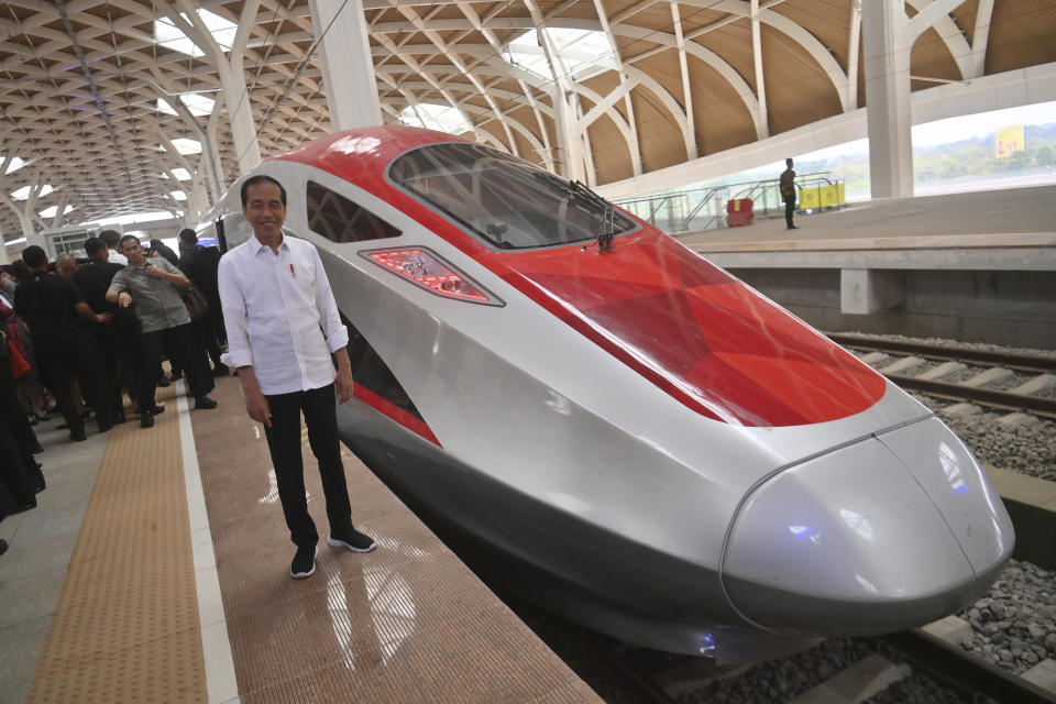 Indonesian President Joko Widodo stands near high-speed railway before a test ride at Halim station in Jakarta, Indonesia, Wednesday, Sept. 13, 2023. Indonesia's President took a test ride Wednesday on Southeast Asia's first high-speed railway as a key project under China's Belt and Road infrastructure initiative. (Akbar Nugroho Gumay/Pool Photo via AP)