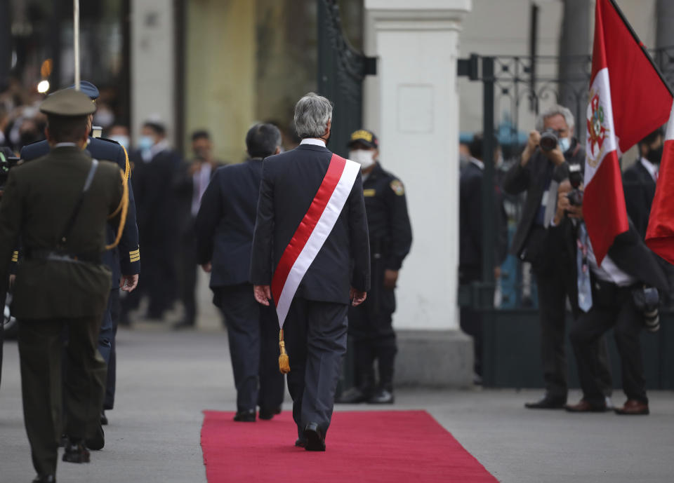 Francisco Sagasti walks out of the Congress building after being sworn-in as the new interim president in Lima, Peru, Tuesday, Nov. 17, 2020. Sagasti's appointment marks a tumultuous week in which thousands took to the streets outraged by Congress' decision to oust popular ex-President Martín Vizcarra. (AP Photo/Rodrigo Abd)