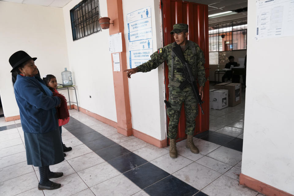 A woman waits for her turn to vote in a presidential election in Ayora, Ecuador, Sunday, Aug. 20, 2023. The election was called after President Guillermo Lasso dissolved the National Assembly by decree in May to avoid being impeached. (AP Photo/Dolores Ochoa)