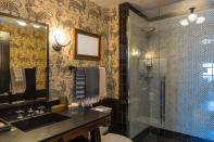 <p><span>This bathroom has uniquely crafted shower and a modern vanity.</span></p>