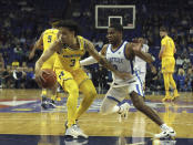 Michigan Wolverines' Jaelin Llewellyn (3) dribbles past Kentucky Wildcats' Sahvir Wheeler (2) during an NCAA basketball game between Michigan Wolverines and Kentucky Wildcats at the O2 Arena, in London, Sunday, Dec.4, 2022. (AP Photo/Ian Walton)