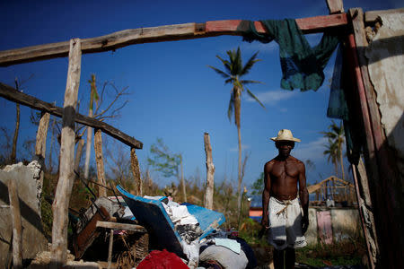 Liface Luc, 66, poses for a photograph in his destroyed house after Hurricane Matthew hit Jeremie, Haiti, October 15, 2016. "I don't need to say nothing, my house explains everything. It's completely flat. I lost everything; my crops, my animals, so I have nothing left. It's like my two hands had been cut. What can I say? I'm at death's door," said Luc. REUTERS/Carlos Garcia Rawlins