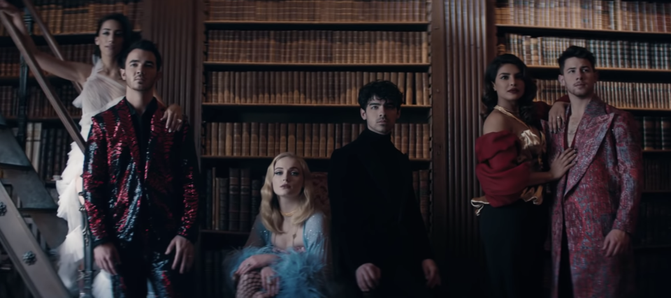 The brothers pose with their significant others at the end of the Sucker music video.