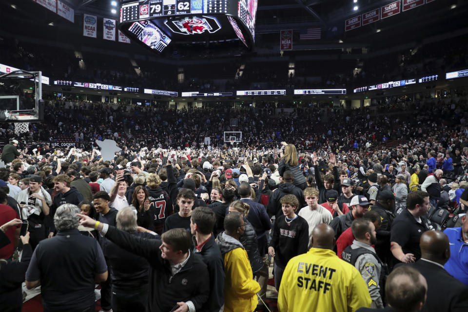 South Carolina fans take over the court after South Carolina upset Kentucky during an NCAA college basketball game Tuesday, Jan. 23, 2024, in Columbia, S.C. South Carolina won 79-62. (AP Photo/Artie Walker Jr.)