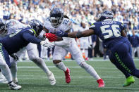 Tennessee Titans running back Derrick Henry is stopped just short of the goal line by Seattle Seahawks linebacker Jordyn Brooks (56) and Seattle Seahawks defensive end Kerry Hyder (51) during the second half of an NFL football game, Sunday, Sept. 19, 2021, in Seattle. Henry scored on the next play and the extra point was good to tie the game at 30. (AP Photo/Elaine Thompson)