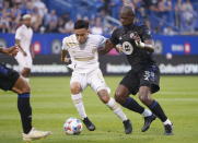 Atlanta United midfielder Ezequiel Barco fends off CF Montreal defender Kamal Miller, right, during the first half of an MLS soccer match Wednesday, Aug. 4, 2021, in Montreal. (Paul Chiasson/The Canadian Press via AP)