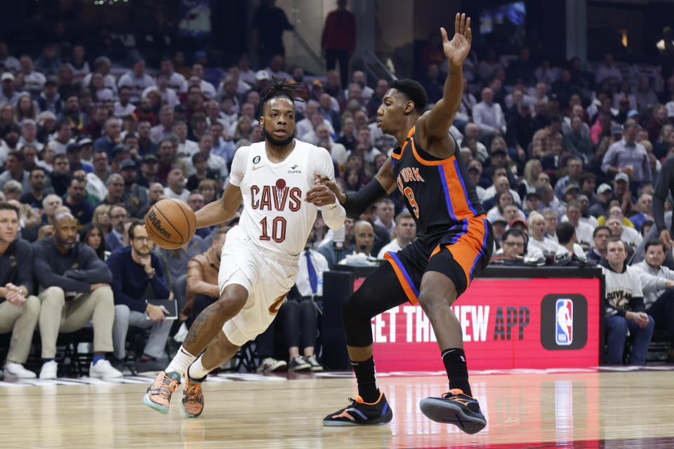 Cleveland Cavaliers guard Darius Garland (10) drives against New York Knicks guard RJ Barrett (9) during the first half of Game 2 of an NBA basketball first-round playoff series Tuesday, April 18, 2023, in Cleveland. (AP Photo/Ron Schwane)
