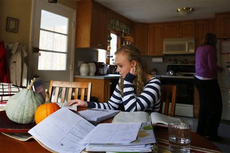 Seventeen year-old Hannah Steenhuysen works on her homework at her home in Rehobeth, Massachusetts October 25, 2013. REUTERS/Brian Snyder