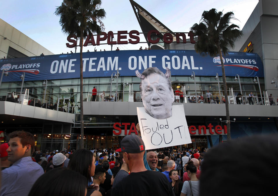 A Clippers fan holds a sign of owner Donald Sterling before a playoff game in 2014, after a coalition of activists and civil rights leaders attend the 