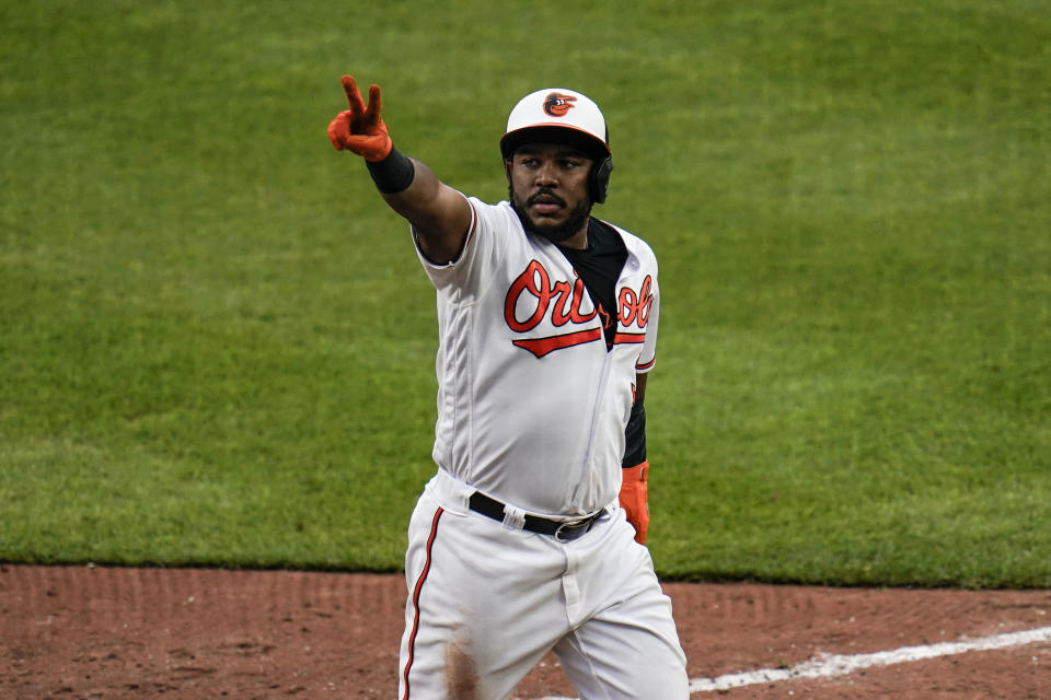 Baltimore Orioles' Maikel Franco gestures after hitting a two-run home run off New York Yankees relief pitcher Wandy Peralta (58) during the seventh inning of a baseball game, Sunday, May 16, 2021, in Baltimore. Orioles' Pedro Severino scored on the play. (AP Photo/Julio Cortez)