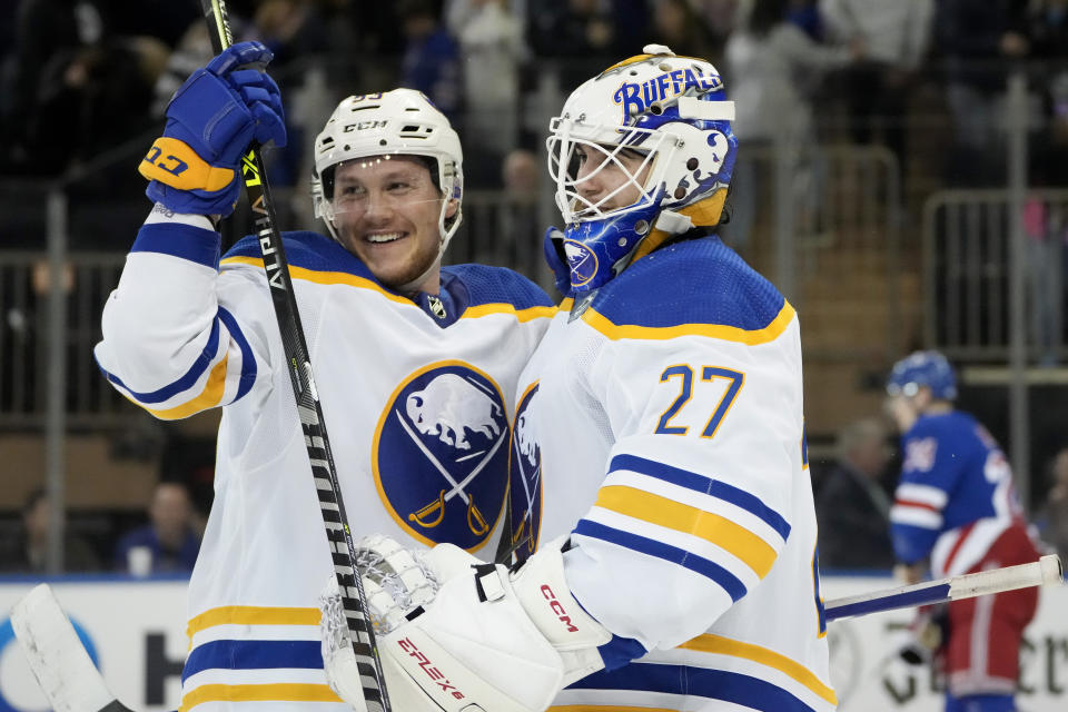 Buffalo Sabres goaltender Devon Levi, right, celebrates with left wing Jeff Skinner, left, after making the game-winning save against New York Rangers right wing Kaapo Kakko (24) during the overtime shootout period of an NHL hockey game, Monday, April 10, 2023, in New York. (AP Photo/John Minchillo)