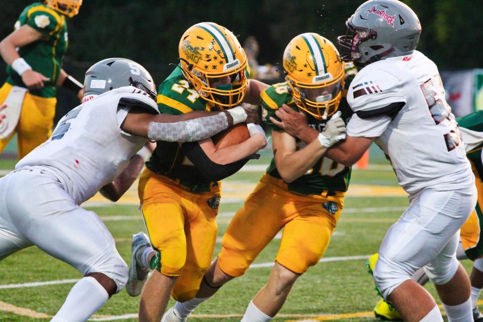 Blackhawk's Zach Ours looks for running room against Ambridge as Connor McGraw lays a lead block Friday night in Week 3.