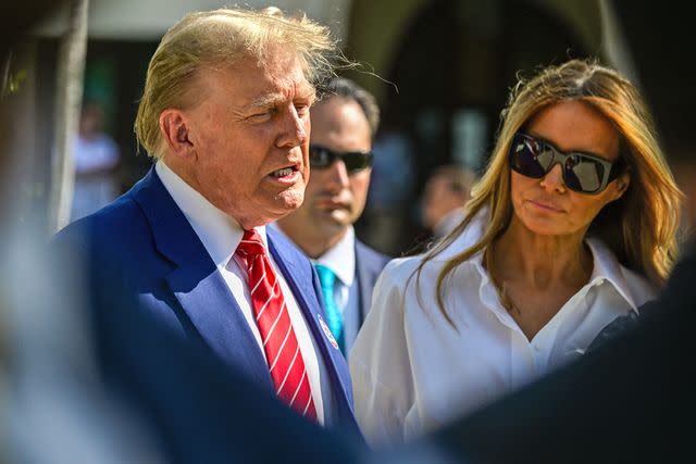 <p>GIORGIO VIERA/AFP via Getty</p> Donald Trump, accompanied by his wife, Melania Trump, speaks to reporters after leaving a Palm Beach polling station on March 19, 2024