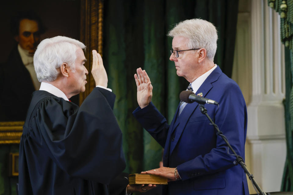 Texas Supreme Court Chief Justice Nathan Hecht, left, swears in Lt. Gov. Dan Patrick, right, before the first day of Texas Attorney General Ken Paxton's impeachment trial in the Senate chambers at the Texas State Capitol in Austin, Texas, Tuesday, Sept. 5, 2023. (Juan Figueroa/The Dallas Morning News via AP, Pool)