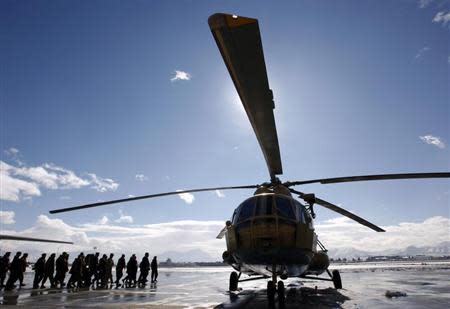 An Afghan Defence Ministry delegation approaches a refurbished newly arrived MI-17 helicopter at the military airport in Kabul January 17, 2008. REUTERS/Ahmad Masood