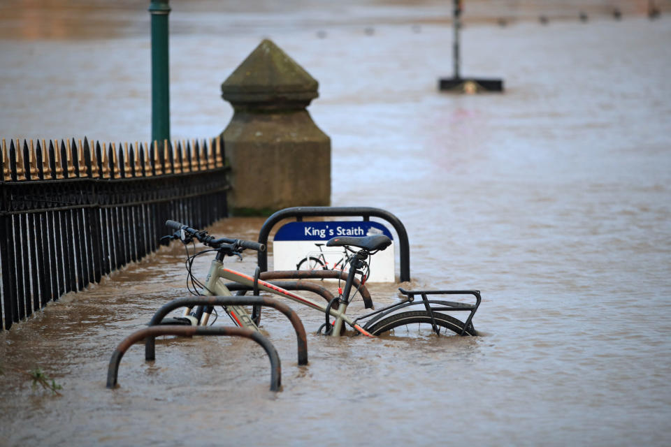 A cycle rack engulfed by floodwater after the River Ouse burst its banks in York. (PA)