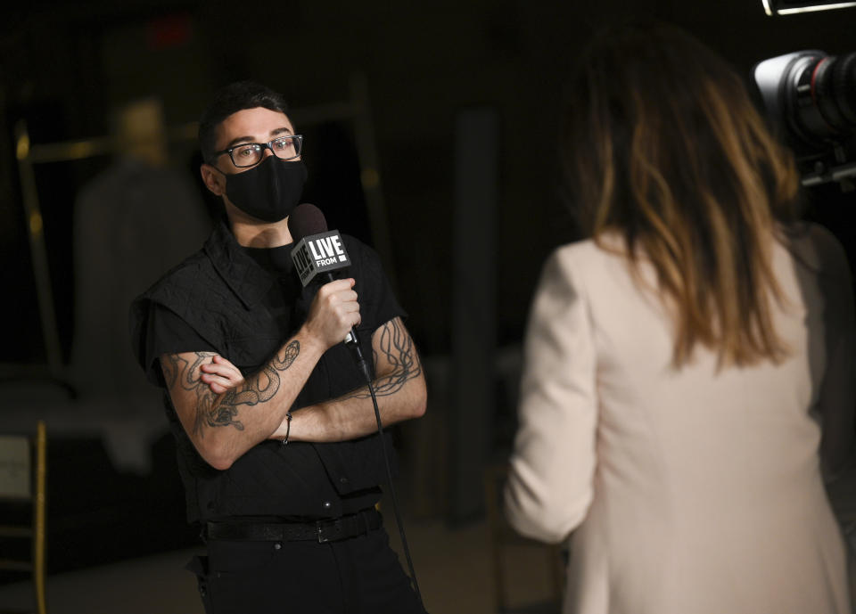 Designer Christian Siriano, left, speaks with media before his Fall/Winter 2021 fashion show at Gotham Hall during New York Fashion Week on Thursday, Feb. 25, 2021, in New York. (Photo by Evan Agostini/Invision/AP)