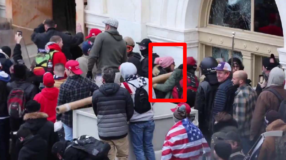This FBI still photo shows Rachel Powell of Mercer County, Pennsylvania, allegedly using a pipe to ram a window at the U.S. Capitol on Jan. 6. Powell was arrested Feb. 4 for her involvement in the riot. The FBI drew a red box around her to identify her in charging documents.