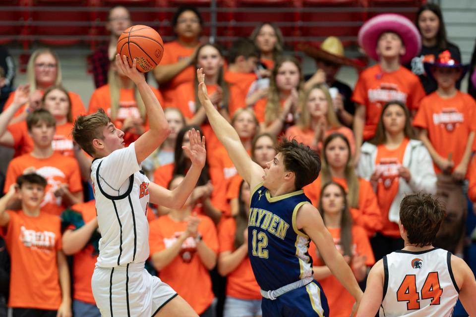 Hayden's Kade Mitchell (12) defends against Beloit’s Jackson Cheney (11) during State Basketball March. 6, 2024 at Hutchinson Sports Arena.