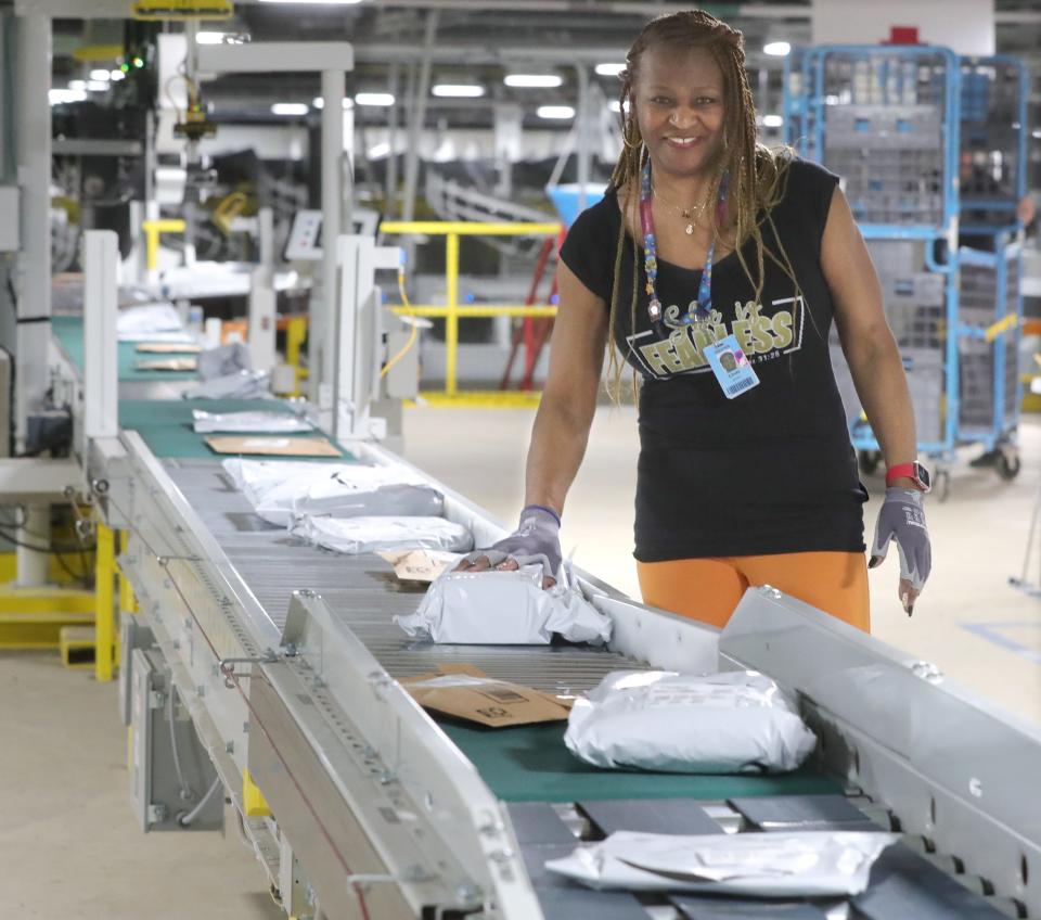 Akron Amazon Fulfillment Center worker Linda Jones inspects package labels as they head out for shipping.