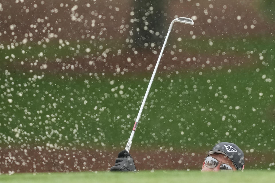 Phil Mickelson watches his shot from the bunker on the seventh hole during the weather delayed third round of the Masters golf tournament at Augusta National Golf Club on Saturday, April 8, 2023, in Augusta, Ga. (AP Photo/David J. Phillip)