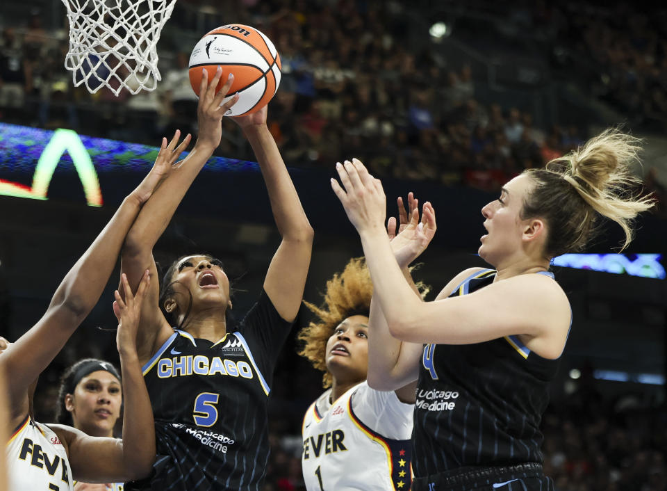 Chicago Sky forward Angel Reese (5) and guard Marina Mabrey (4) battle Indiana Fever forward Aliyah Boston (7) and forward NaLyssa Smith (1) for a rebound during a WNBA basketball game, Sunday, June 23, 2024, in Chicago. (Eileen T. Meslar/Chicago Tribune via AP)