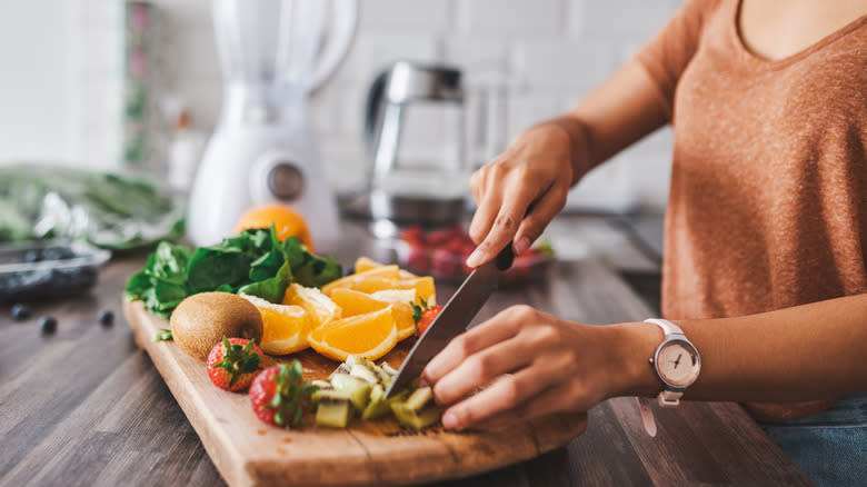 woman chopping fruit