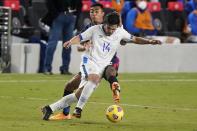 U.S. defender Julian Araujo, rear, attempts to steal the ball from El Salvador defender Andres Flores (14) during the second half of an international friendly soccer match Wednesday, Dec. 9, 2020, in Fort Lauderdale, Fla. (AP Photo/Wilfredo Lee)