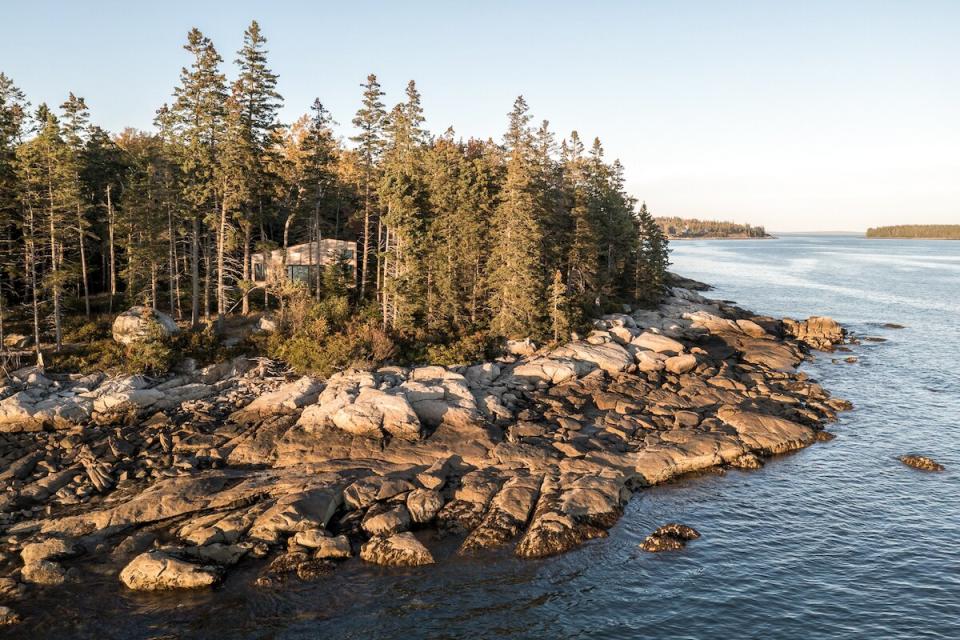 The primary bedroom cabin sits in a natural clearing amongst the trees, allowing for a water view and copious sunlight.  The boulder-studded coast offers gently sloping paths to the ocean for a quick dip.