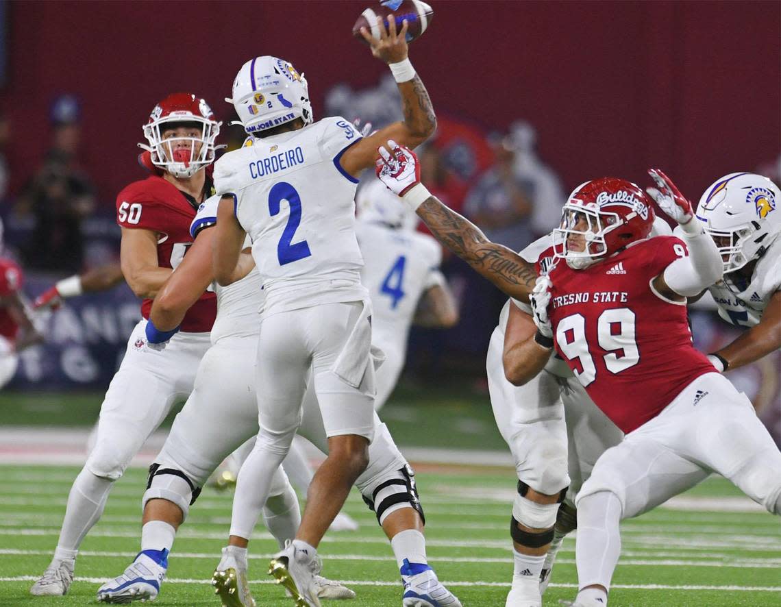 Fresno State’s.David Perales, right, pressures San Jose State quarterback Chevan Cordeiro in first half action Saturday, Oct. 15, 2022 in Fresno.