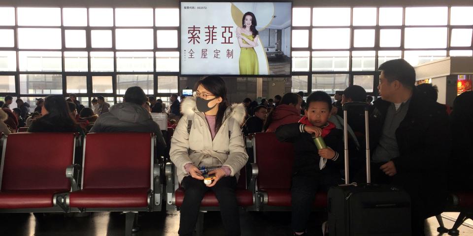 A woman wearing a mask is seen at a waiting area for a train to Wuhan at the Beijing West Railway Station, ahead of Chinese Lunar New Year, in Beijing, China January 20, 2020. REUTERS/Stringer