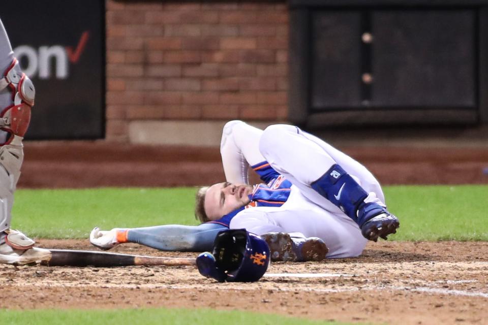 New York Mets first baseman Pete Alonso (20) lays on the ground after getting hit by a pitch in the eighth inning against the Los Angeles Angels on Aug. 26, 2023, at Citi Field