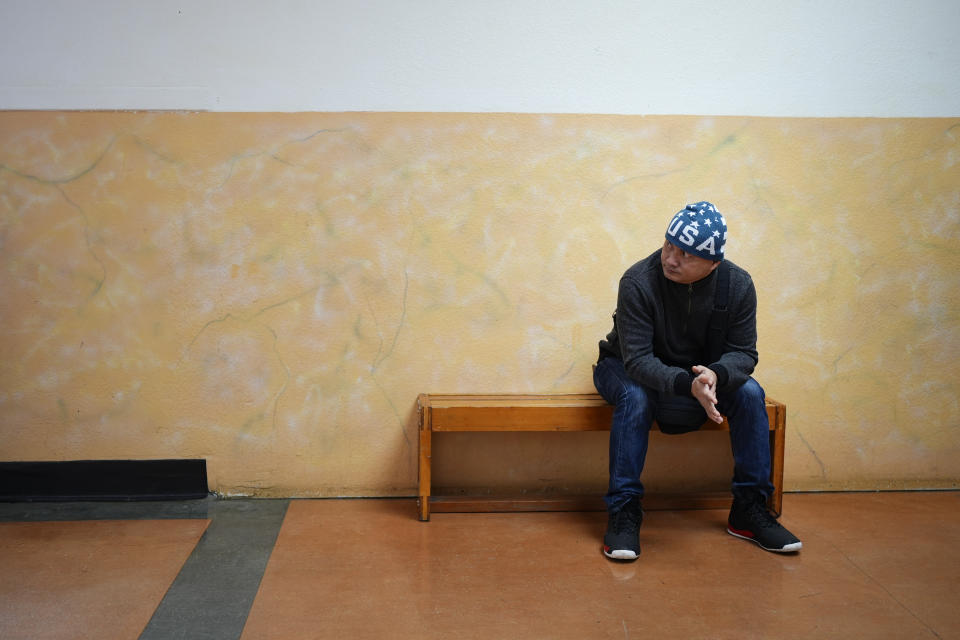 Seafarer Albert Docuyan waits on a bench at El Centro de la Raza, Monday, Feb. 5, 2024, in Seattle. While waiting for backpay, stuck in the U.S., Docuyan’s wife moved from the Philippines to Malaysia to find work that could pay the fees for their children’s school. (AP Photo/Lindsey Wasson)