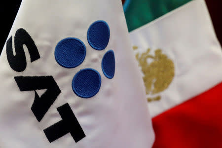 FILE PHOTO: A flag with the logo of the Tax Administration Service (SAT) is seen at their offices in Mexico City, Mexico May 26, 2017. REUTERS/Carlos Jasso/File Photo