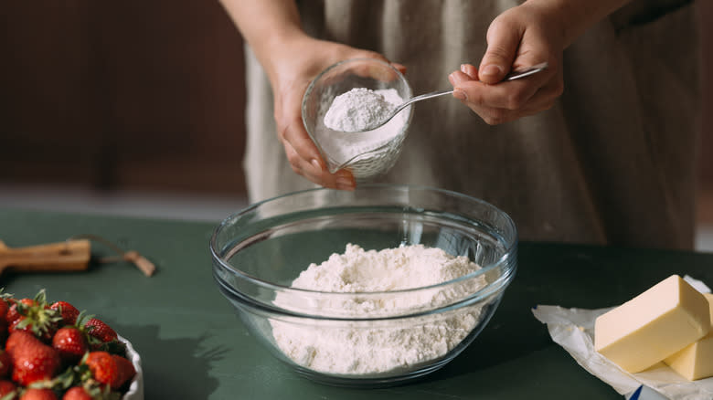 Spooning flour into bowl