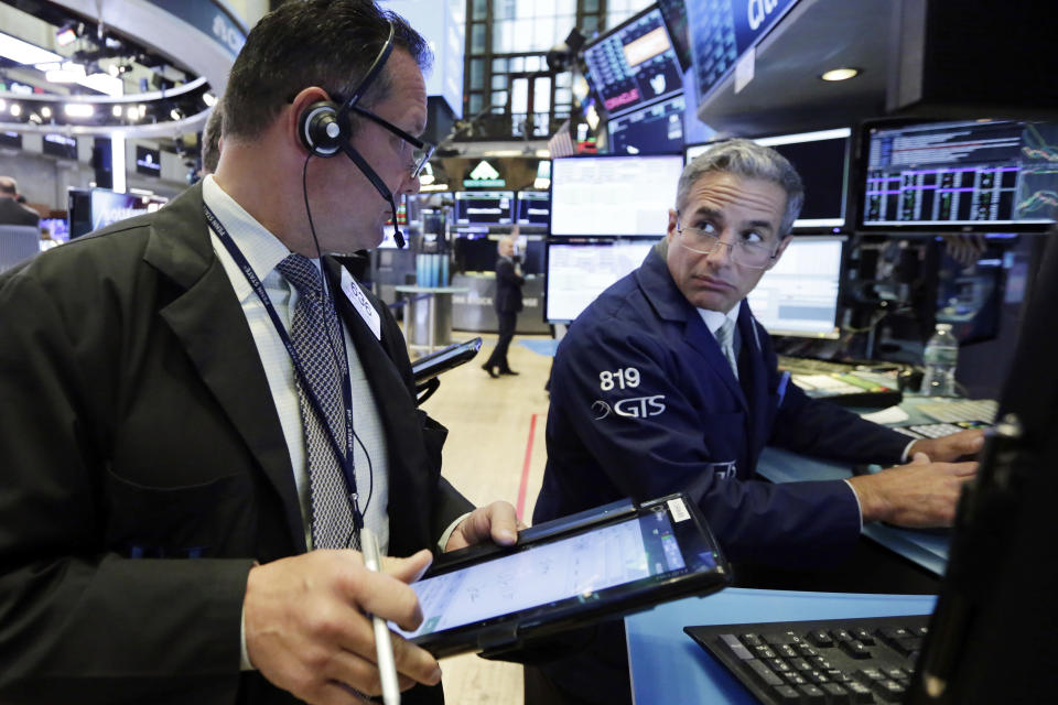 Trader Edward Curran, left, and specialist Anthony Rinaldi work on the floor of the New York Stock Exchange, Monday, July 30, 2018. Stocks are off to a mixed start on Wall Street as gains in banks and energy companies are offset by losses in other sectors. (AP Photo/Richard Drew)