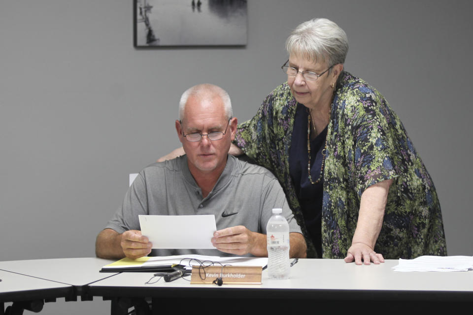 Marion, Kansas Vice Mayor Ruth Herbel, right, confers with fellow City Council member Kevin Burkholder, left, before a council meeting, Monday, Aug. 21, 2023, in Marion, Kansas. It was the council's first meeting since local police raided the weekly newspaper, its publisher's home and Herbel's home on Aug. 11, over allegations that the newspaper and Herbel violated a local business owner's privacy. (AP Photo/John Hanna)