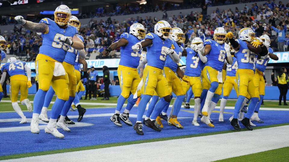 The Los Angeles Chargers celebrate after an interception by safety Alohi Gilman (32) during the second half of an NFL football game against the Buffalo Bills Saturday, Dec. 23, 2023, in Inglewood, Calif. (AP Photo/Ashley Landis)