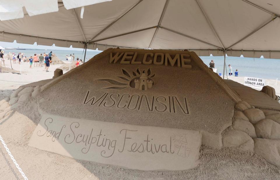 Visitors to the Wisconsin Sand Sculpting Festival are greeted with a sculpture at Red Arrow Park and Beach, Friday, July 14, 2023, in Manitowoc, Wis.