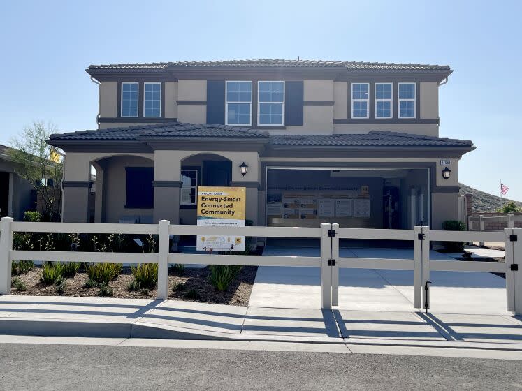 A model home is one of 219 units in two adjacent subdivisions in the Inland Empire city where homes come equipped with rooftop solar panels, on-site battery storage and smart electrical panels that manage home energy use. The homes in the Durango and Oak Shade at Shadow Mountain subdivisions will also be connected to community battery storage as part of a U.S. Department of Energy-funded microgrid project that will also help them keep the lights on during a power outage. (Tony Barboza/Los Angeles Times)