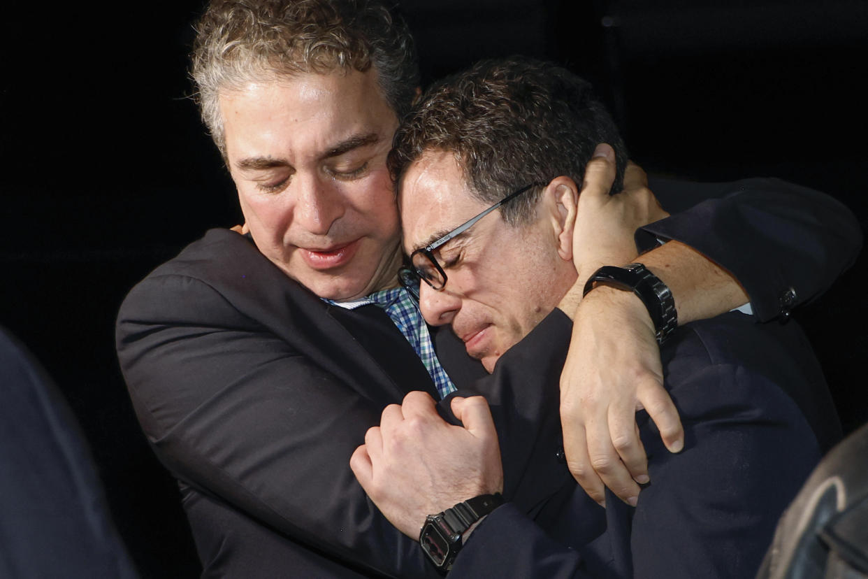 A family member embraces freed American Siamak Namazi.