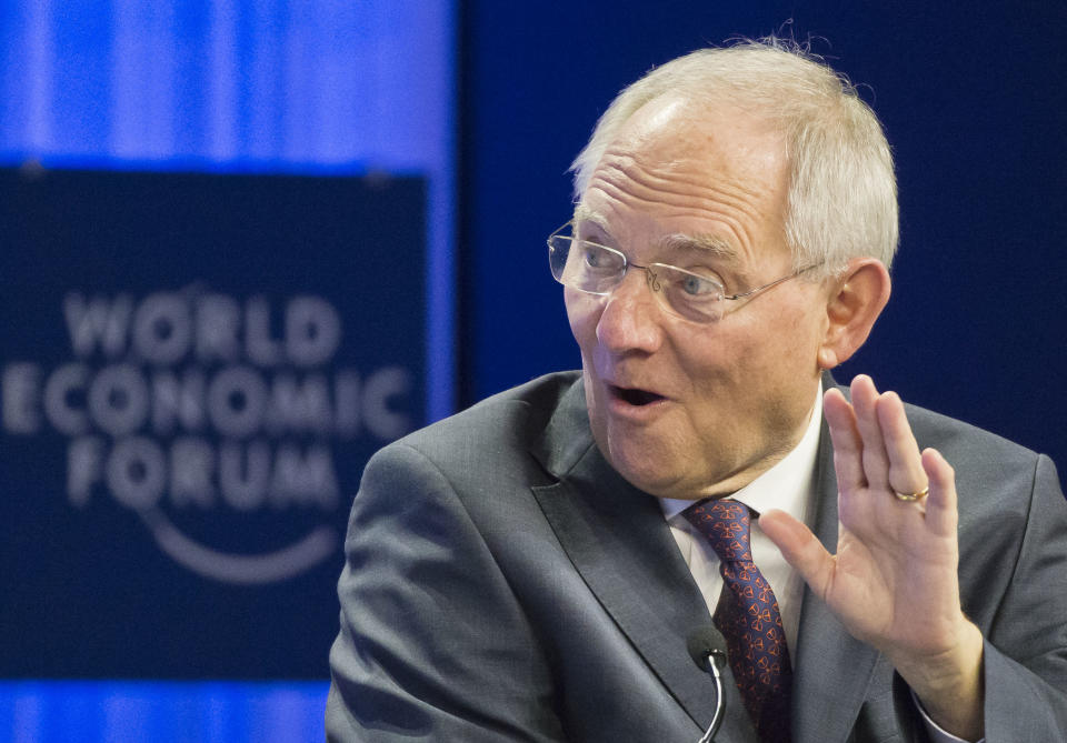 German Finance Minister Wolfgang Schaeuble, gestures as he speaks during a session at the World Economic Forum in Davos, Switzerland, Saturday, Jan. 25, 2014. Leaders gathered in the Swiss ski resort of Davos have made it a top priority to push to reshape the global economy and cut global warming by shifting to cleaner energy sources. Head of the International Monetary Fund Christine Lagarde in the background. (AP Photo/Michel Euler)